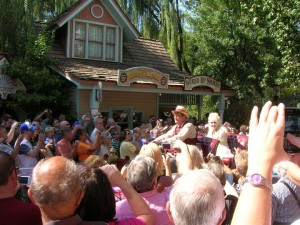 Dolly Parton waves to fans during an annual stop at Dollywood.