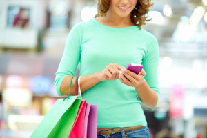 Woman shopping and using her phone apps