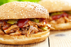 Pulled pork sandwiches with sesame seed buns.